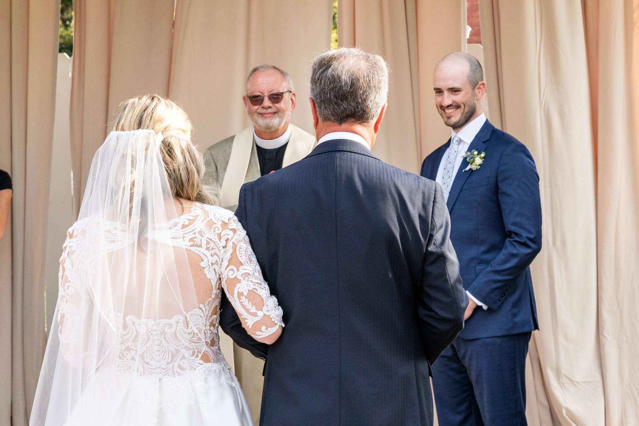 Bride and Father walking down the isle in The Tabby Garden at The Beaufort Inn by Wedding Photographer Susan DeLoach Photography