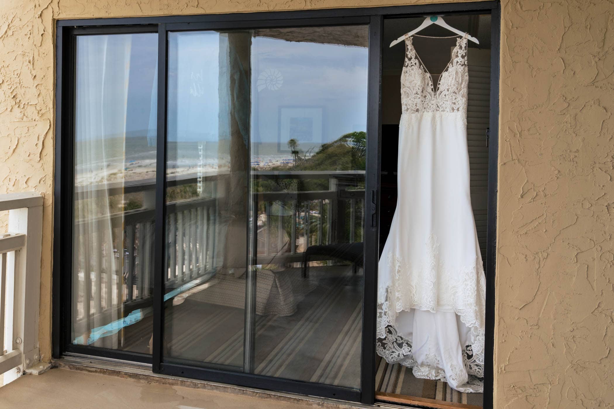 Wedding Dress with Beach refection in sliding glass doors