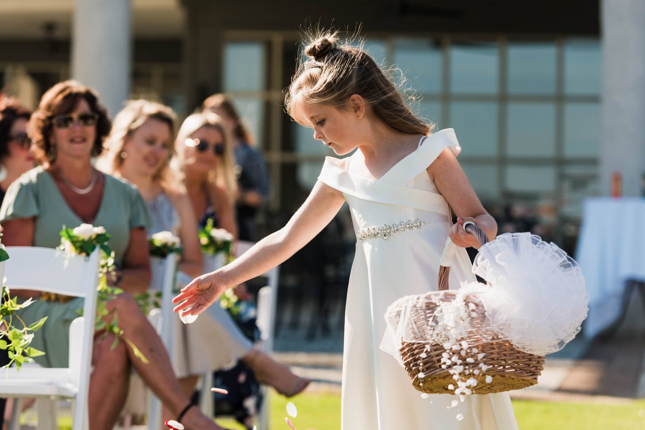 Flower girl throwing flower petals during wedding ceremony by Susan DeLoach Photography SC wedding photographers