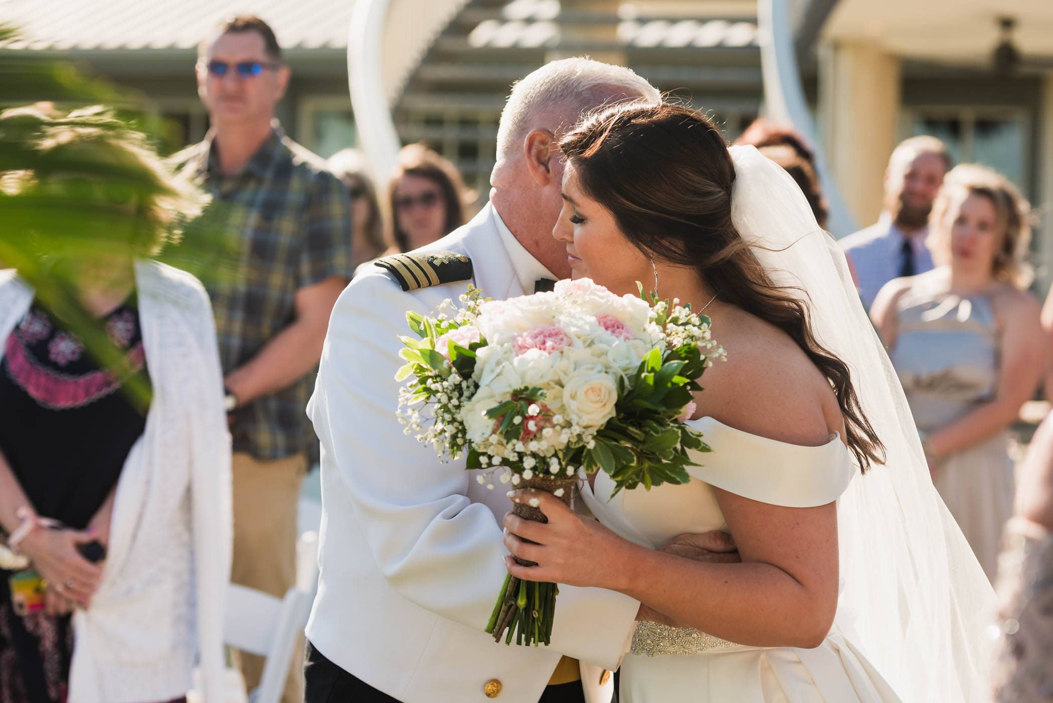 Bride kisses father at the end of the isle during wedding ceremony Dataw Island Club House by Susan DeLoach Photography SC wedding photographers