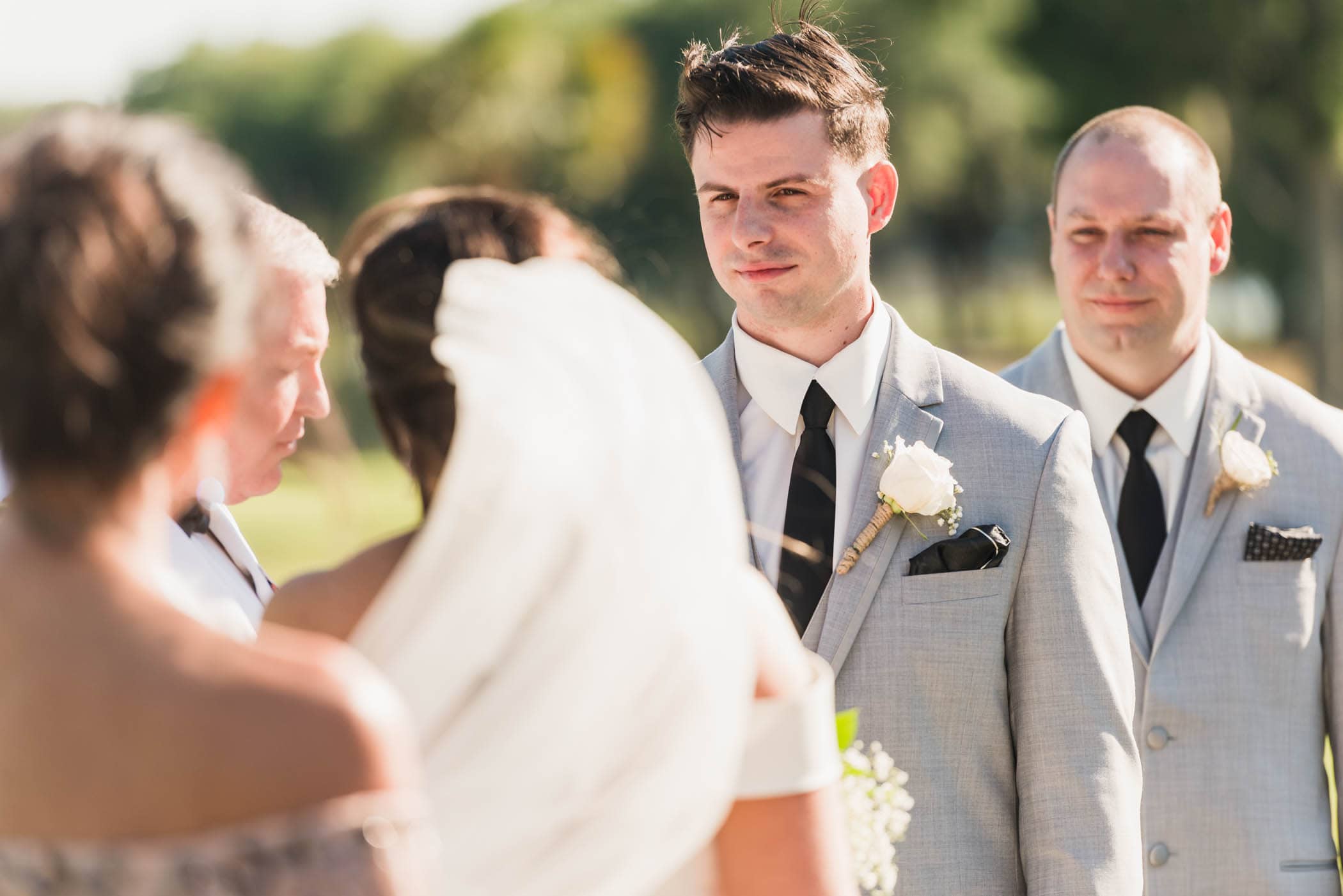 Groom looking at bride during wedding ceremony Dataw Island Club House by Susan DeLoach Photography SC wedding photographers