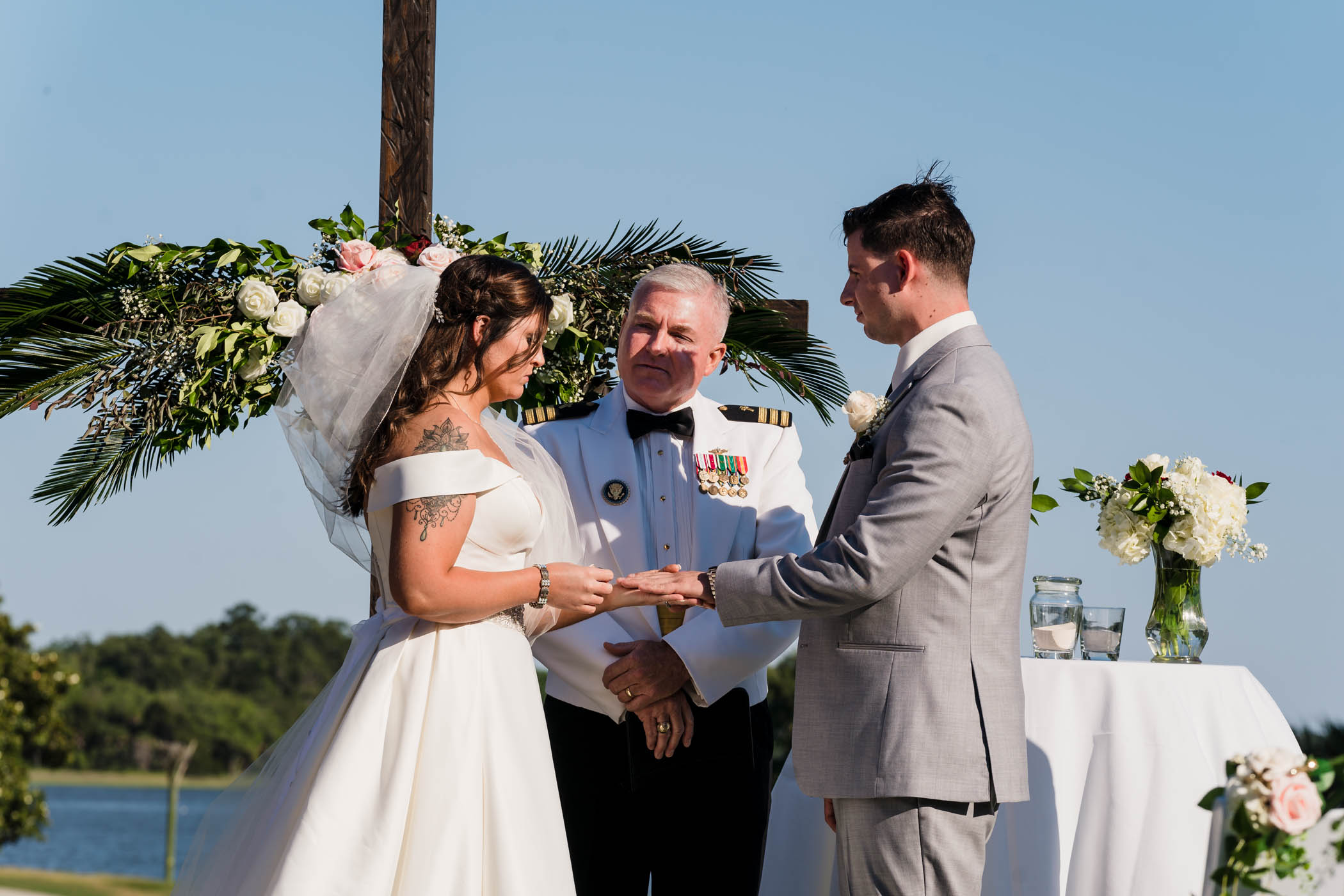 Bride putting ring on grooms finger Dataw Island Club House by Susan DeLoach Photography SC wedding photographers