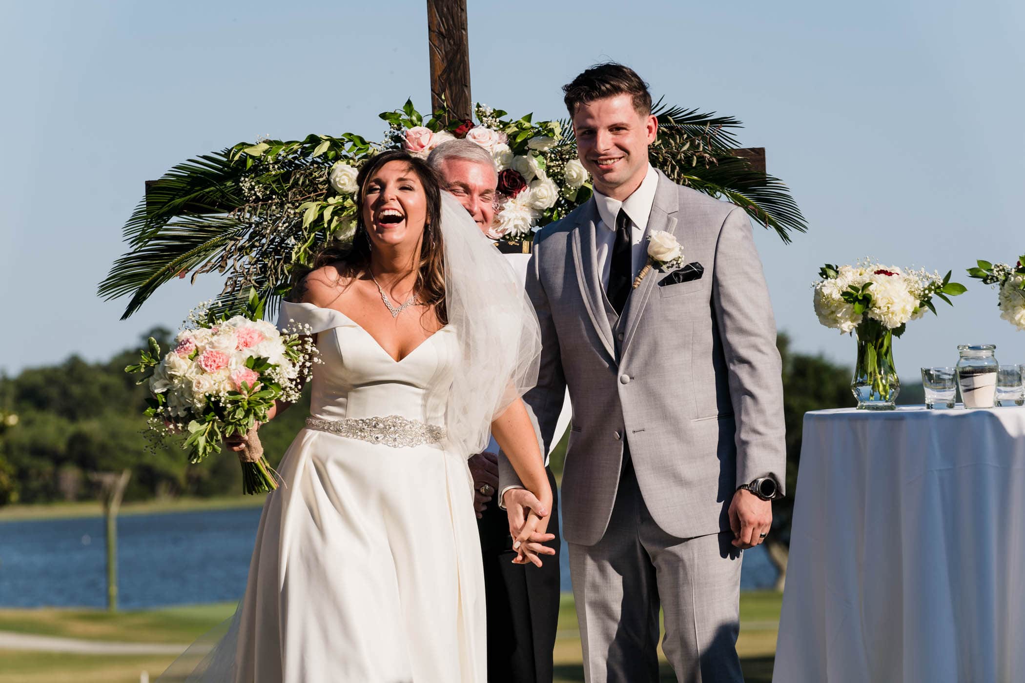 Happy Bride and Groom during recessional at wedding Dataw Island Club House by Susan DeLoach Photography SC wedding photographers