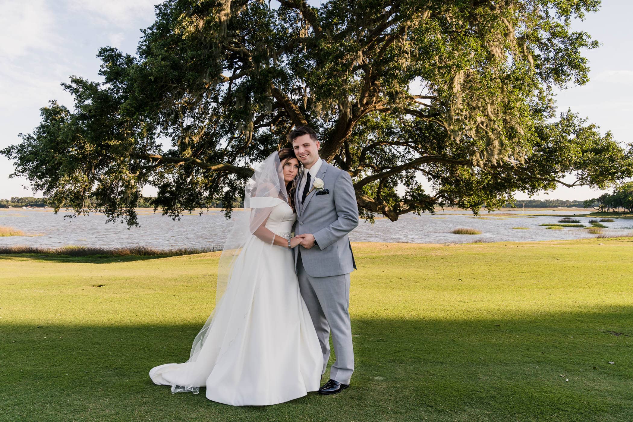 Bride and groom portrait with her head on his shoulder Dataw Island Club House by Susan DeLoach Photography SC wedding photographers