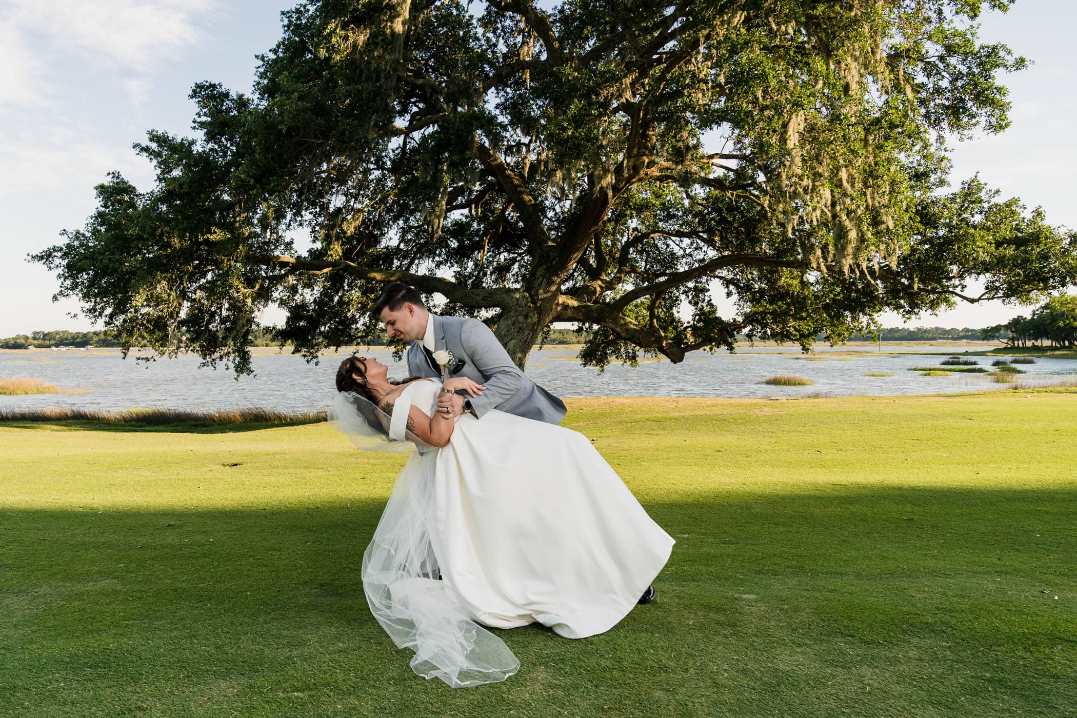 Groom dipping bride on the golf course at Dataw Island Club House by Susan DeLoach Photography SC wedding photographers