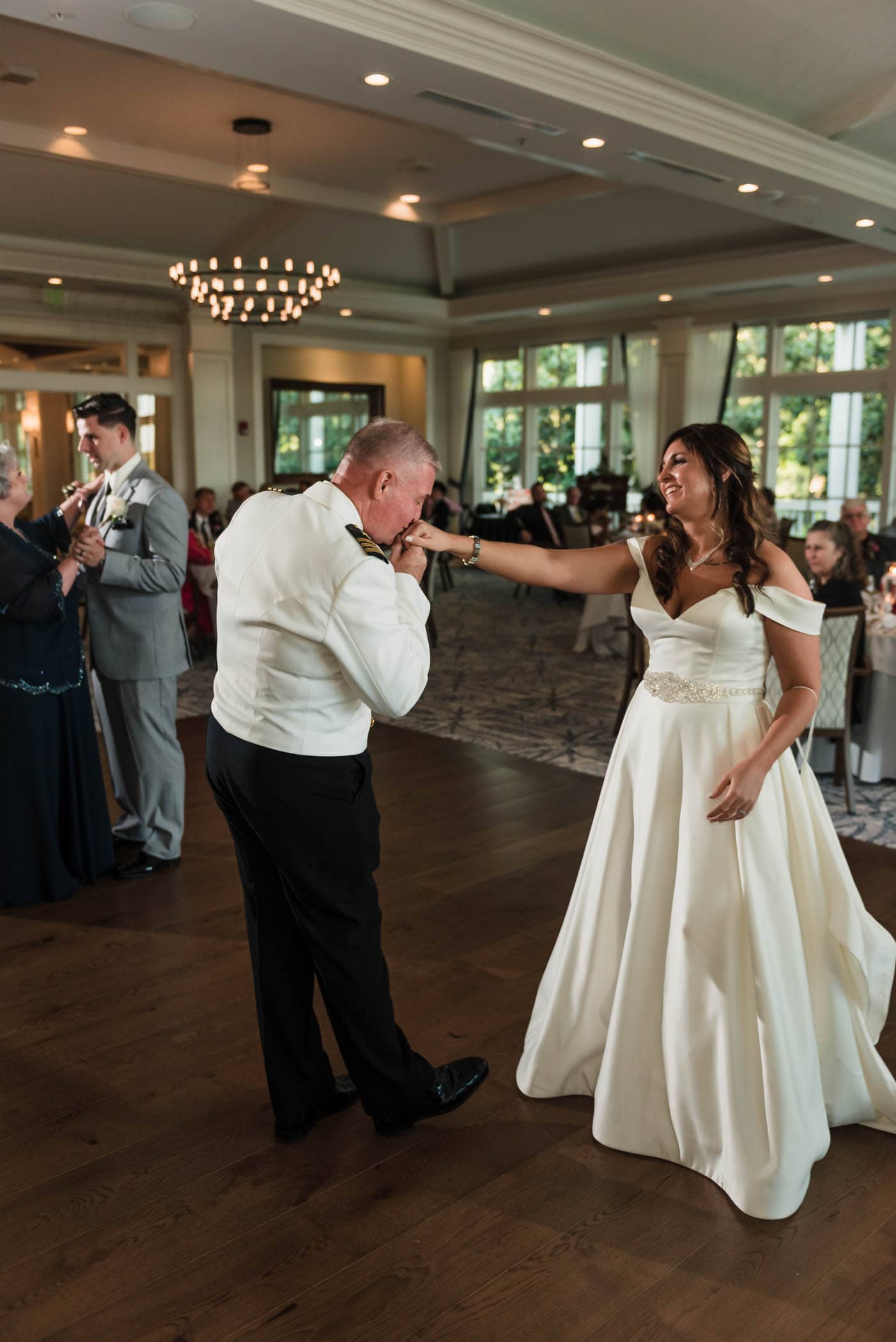 Father of the Bride kissing her hand on the dance floor Dataw Island Club House by Susan DeLoach Photography SC wedding photographers